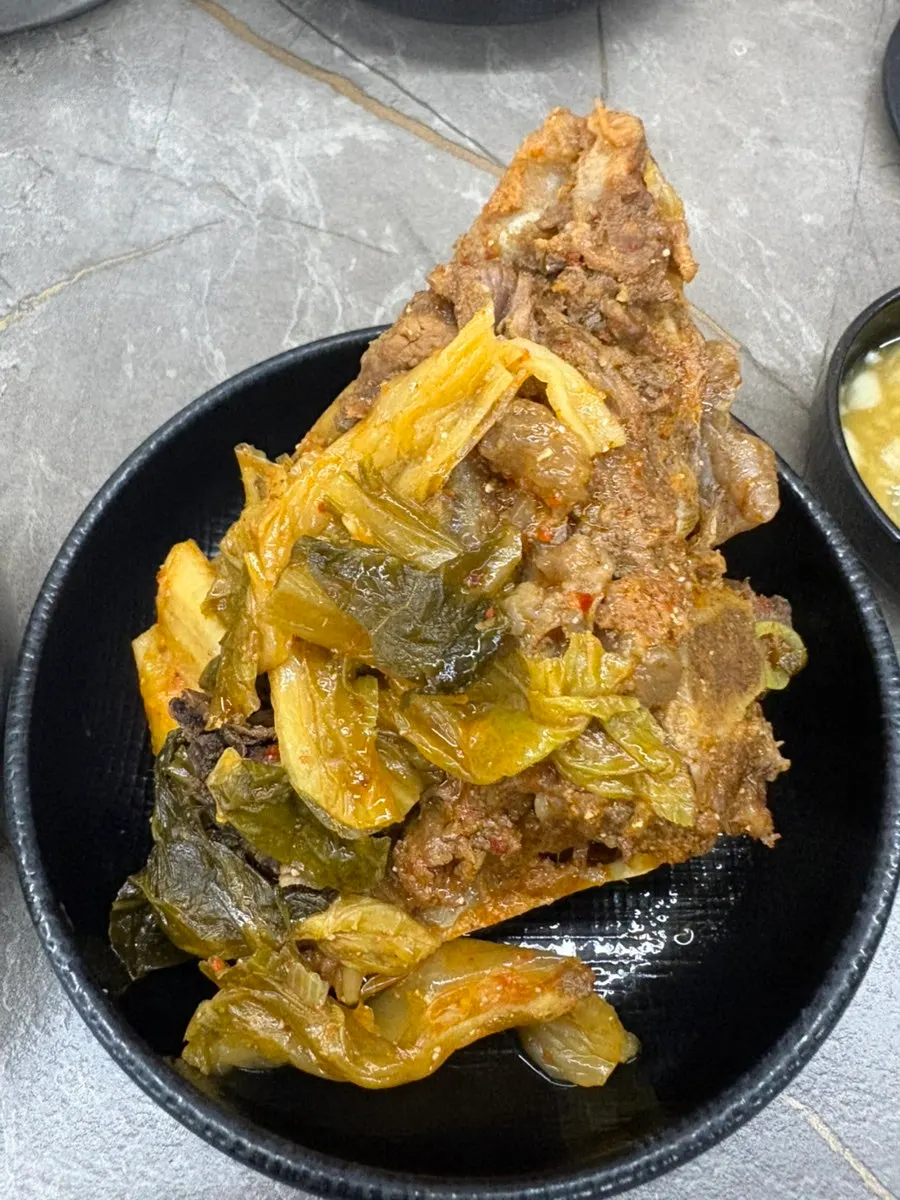 Large gamjatang bone meat held in hand