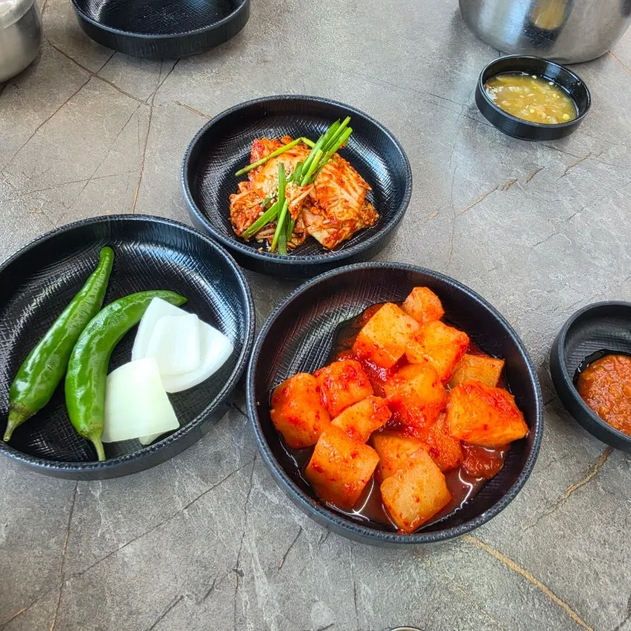Table of side dishes served with the gamjatang