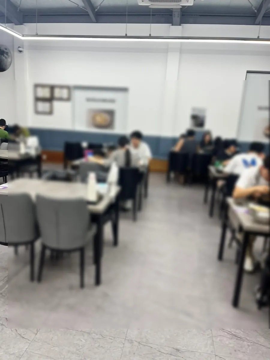Dining hall seating with generous space between tables