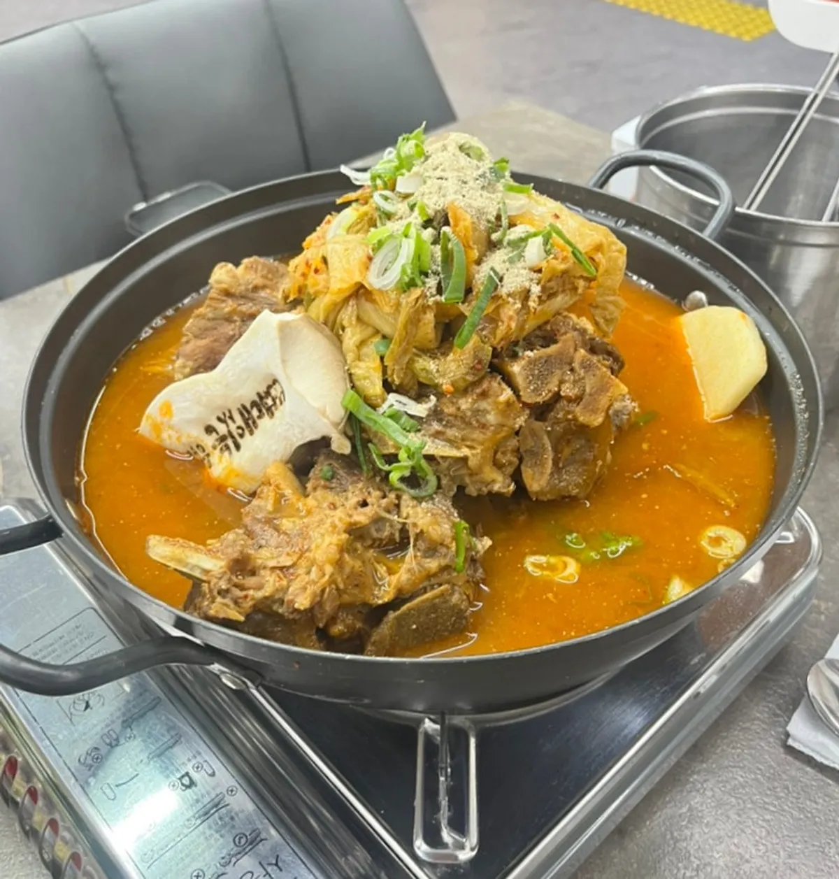 Large-size gamjatang boiling away at the table
