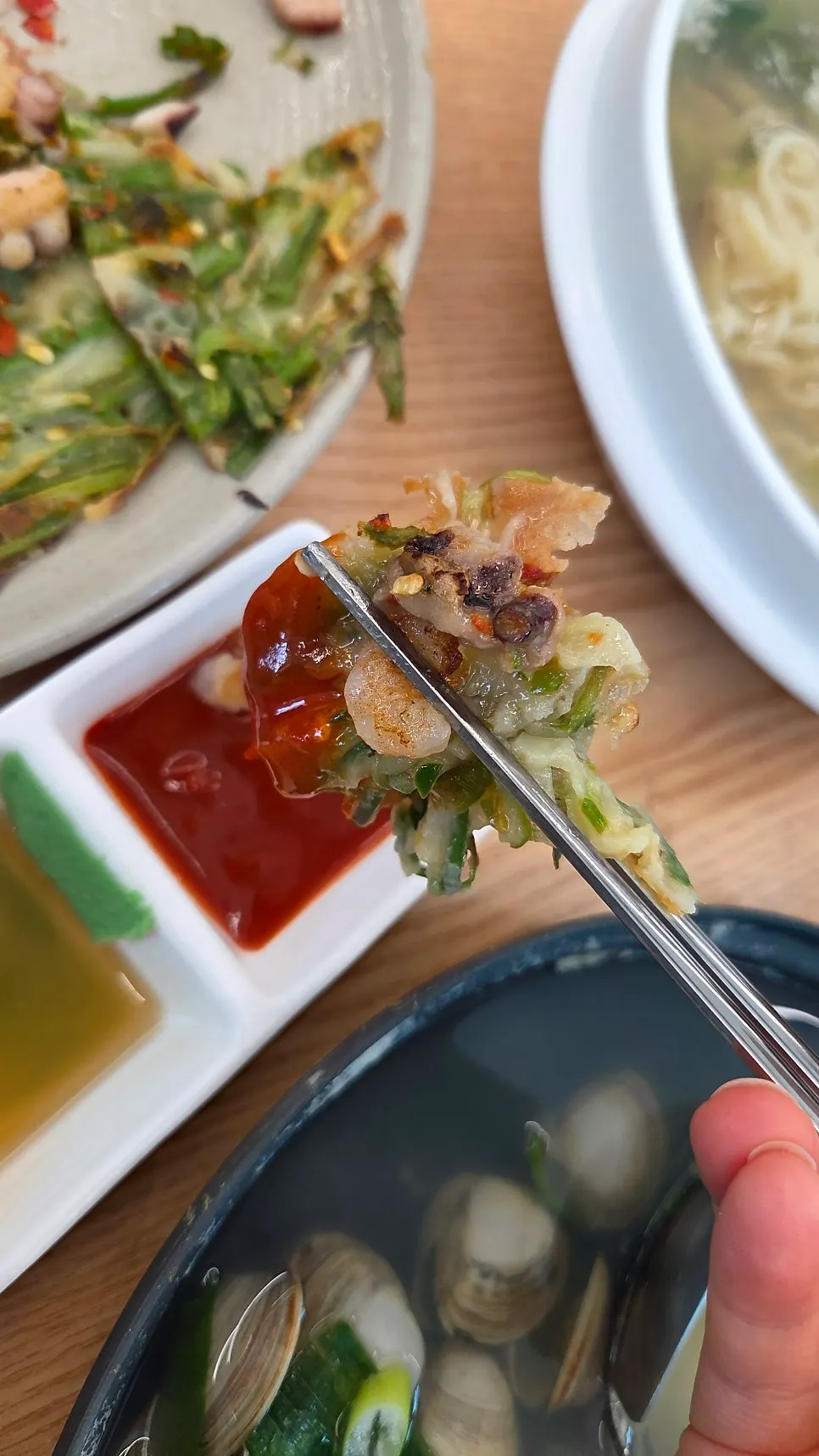A piece of seafood pancake dipped in chojang