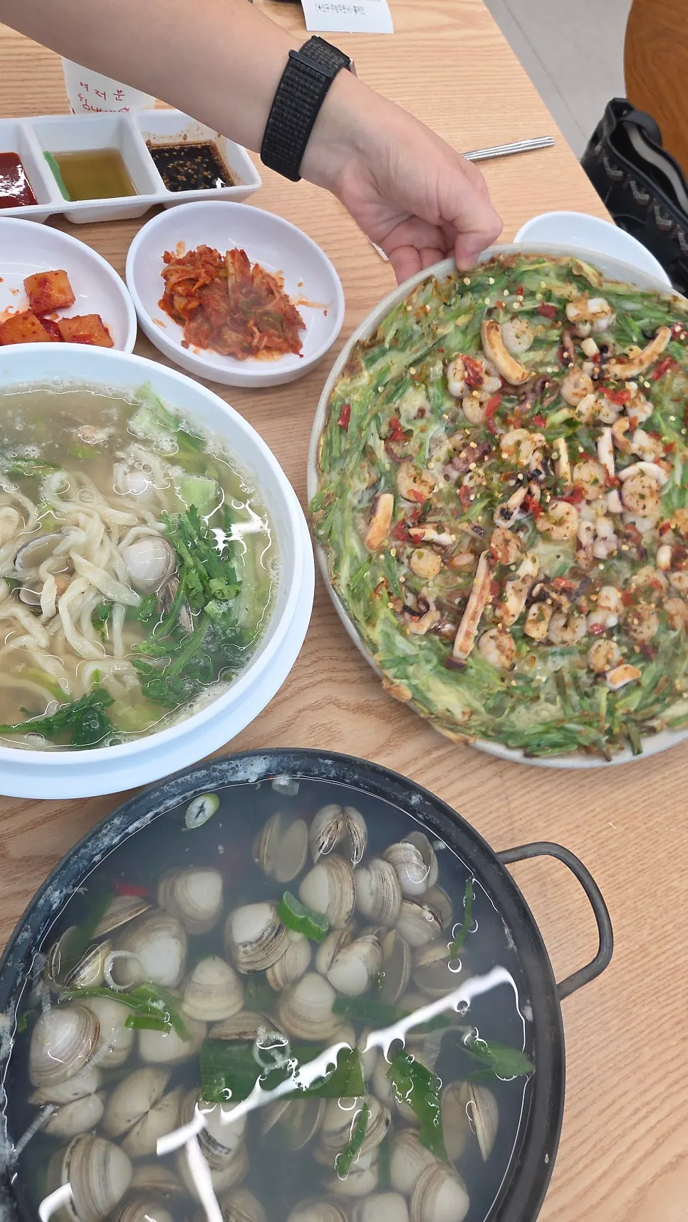 A chopstick-lifted bite of kalguksu noodles