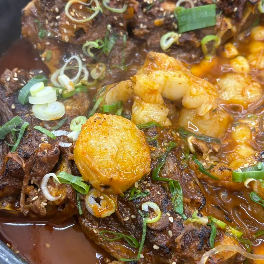 Glass noodles and rice cake added into the bone grill pot