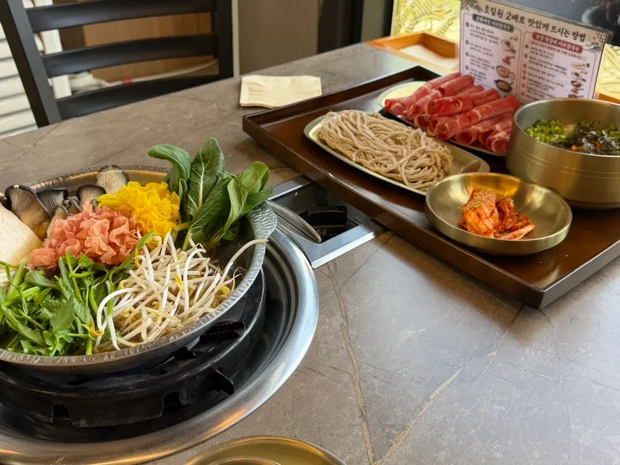 Shabu-shabu pot filled with agaricus mushrooms and vegetables