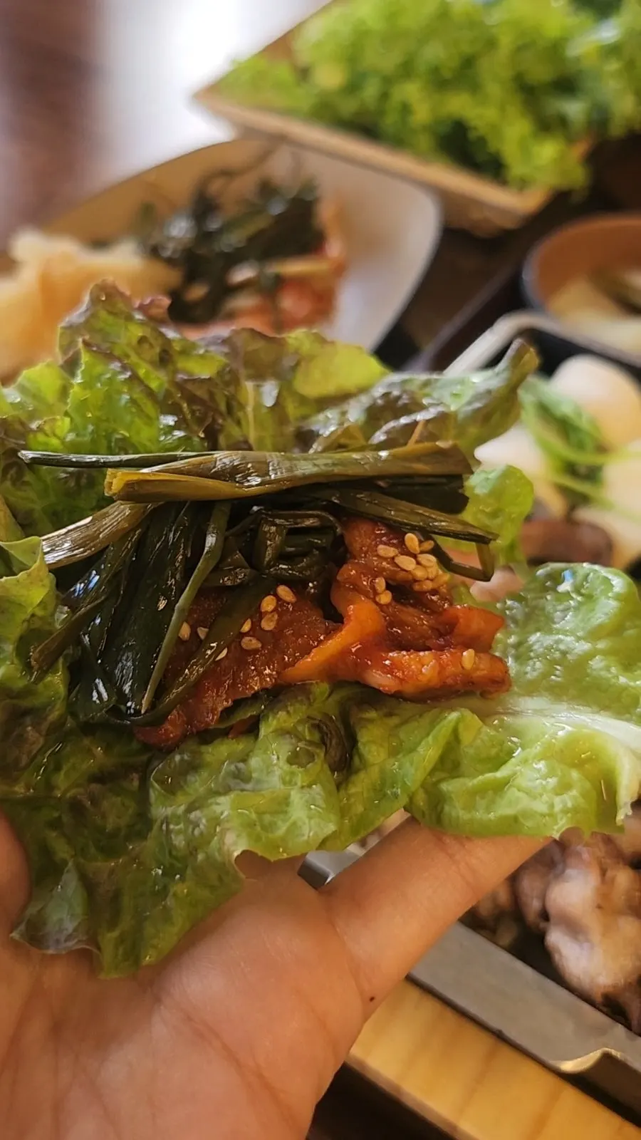 A neatly wrapped bite of pork belly wrap