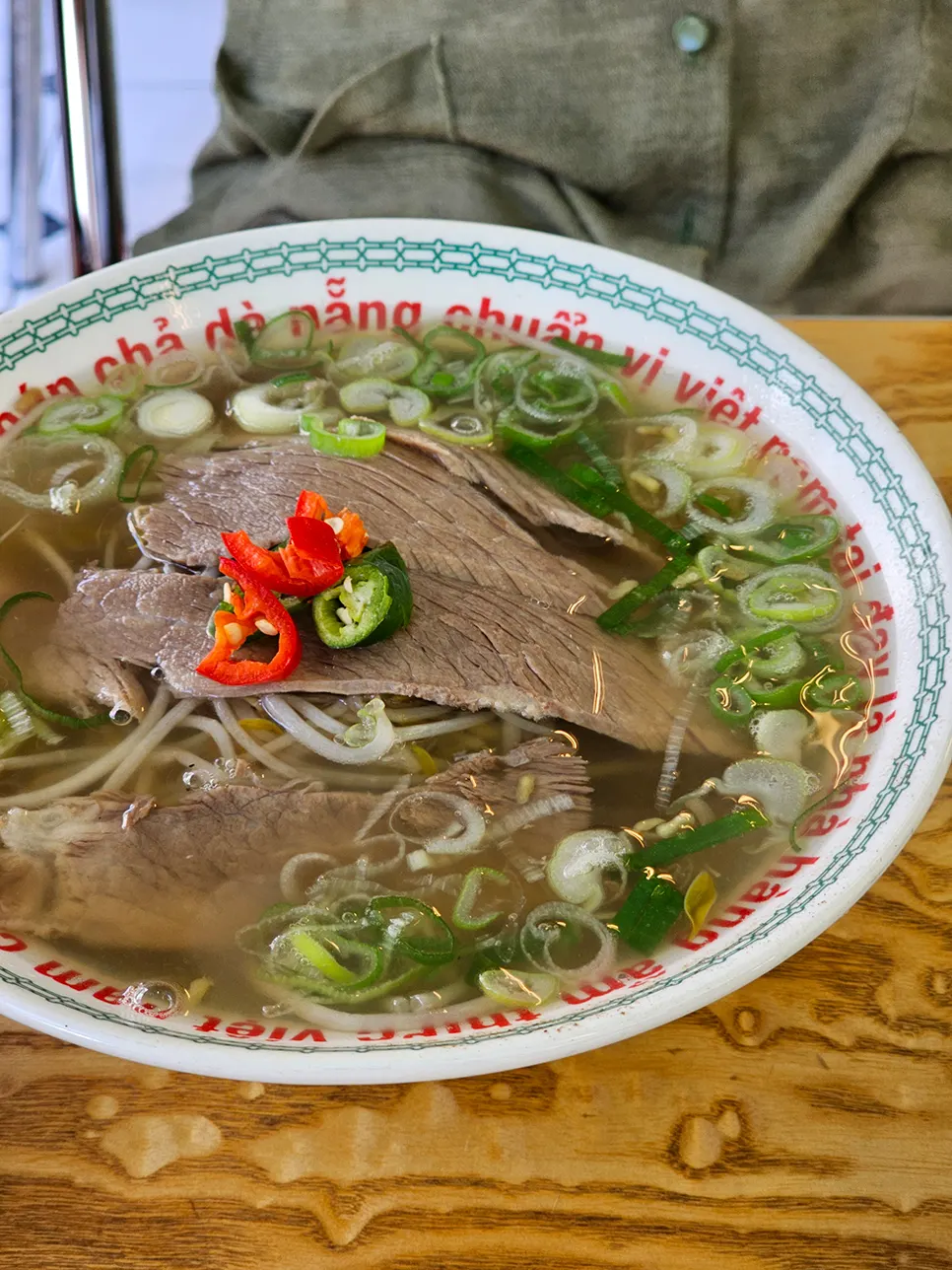 Beef brisket and bean sprout pho topped with scallions and beef