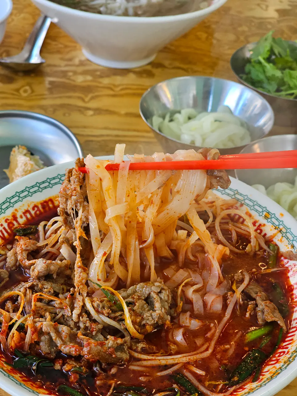 Warming spicy fire-grilled pho with smoky flavor