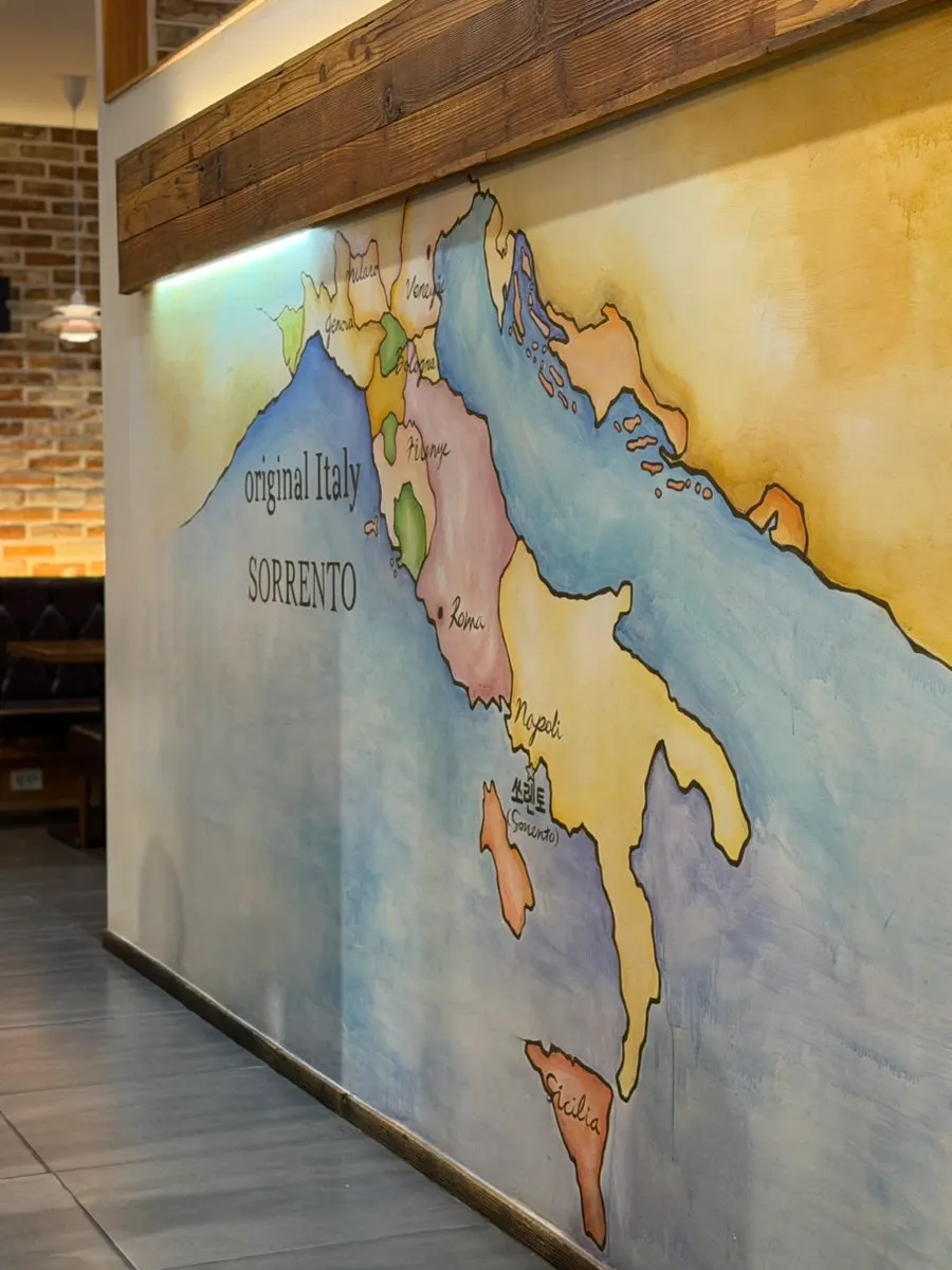 Interior of the restaurant with guests enjoying pizza