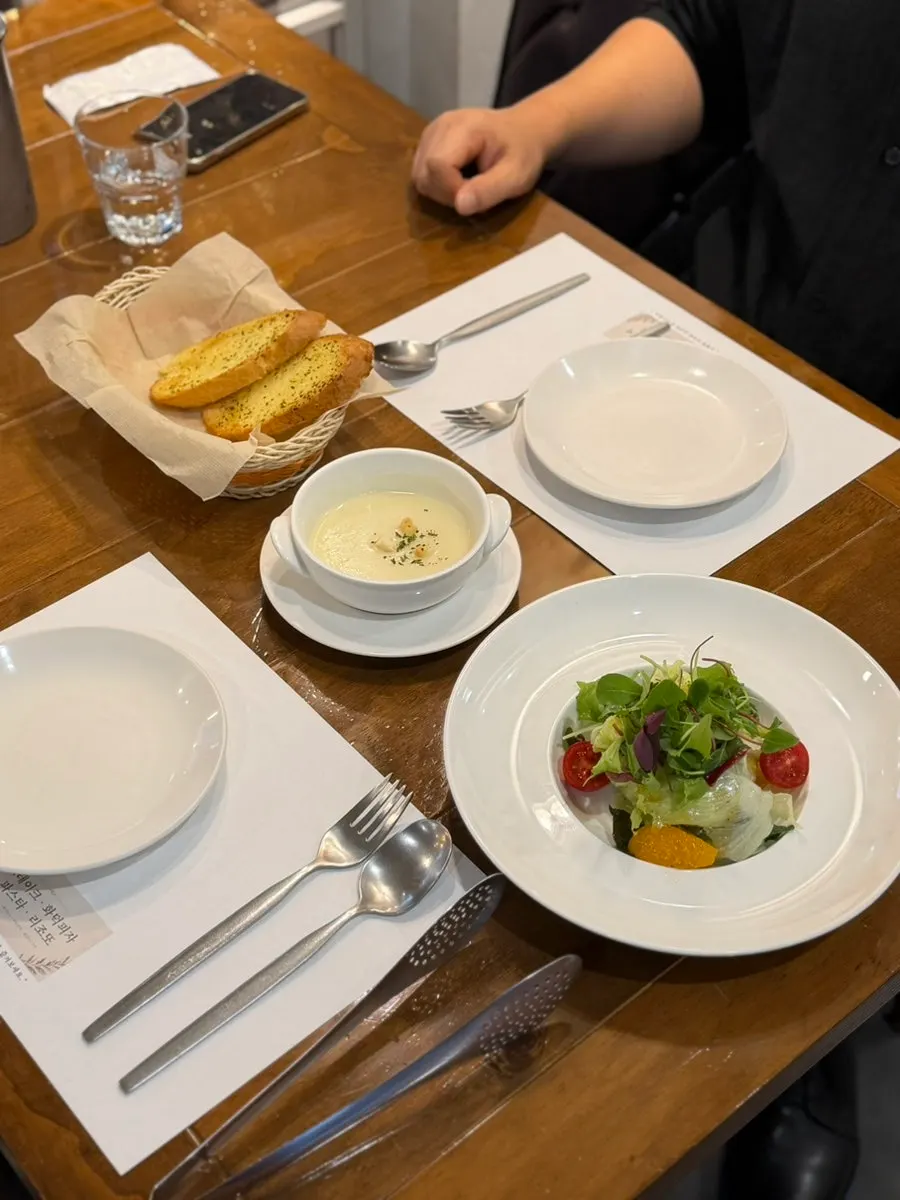 Starter dishes from the set: garlic bread, soup, and salad