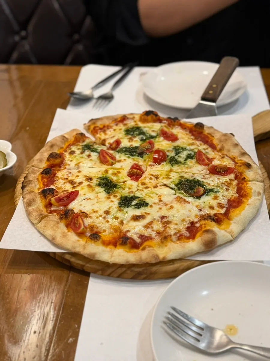 Wood-fired margherita pizza with a generous layer of cheese
