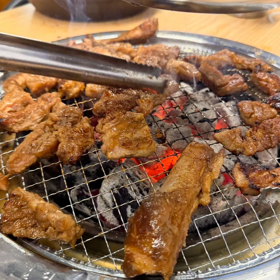 King pork rib lifted whole with tongs