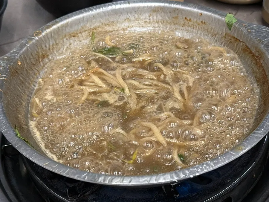 Shabu-shabu meat and vegetables cooking in the broth