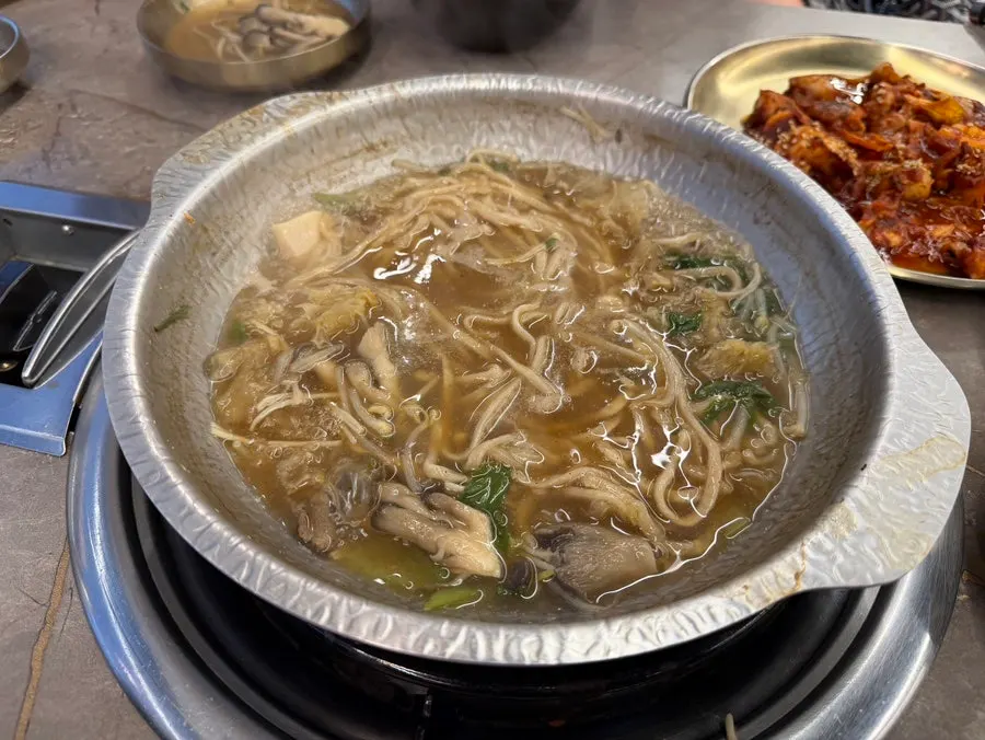 Jjukkumi stir-fry served alongside shabu kalguksu