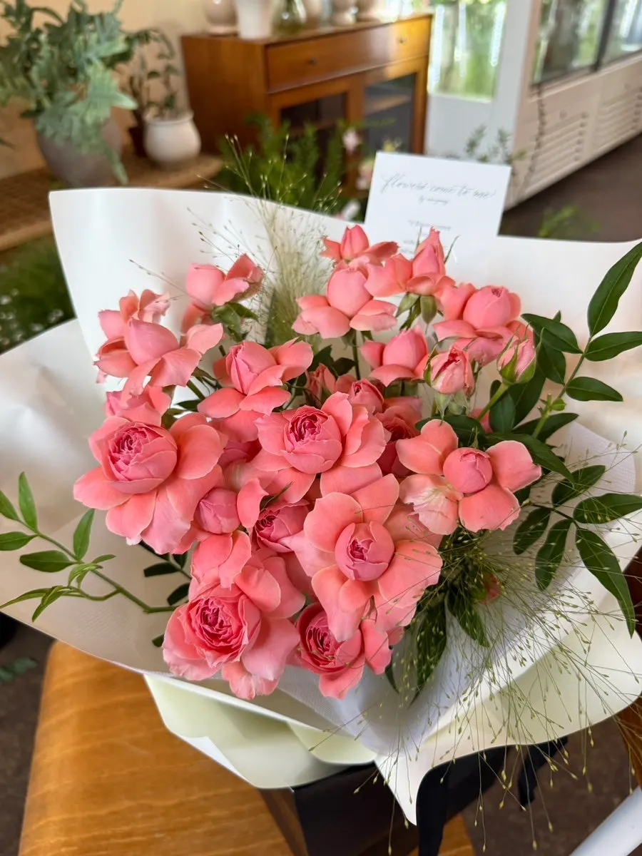 Rose bouquet wrapped in ivory paper