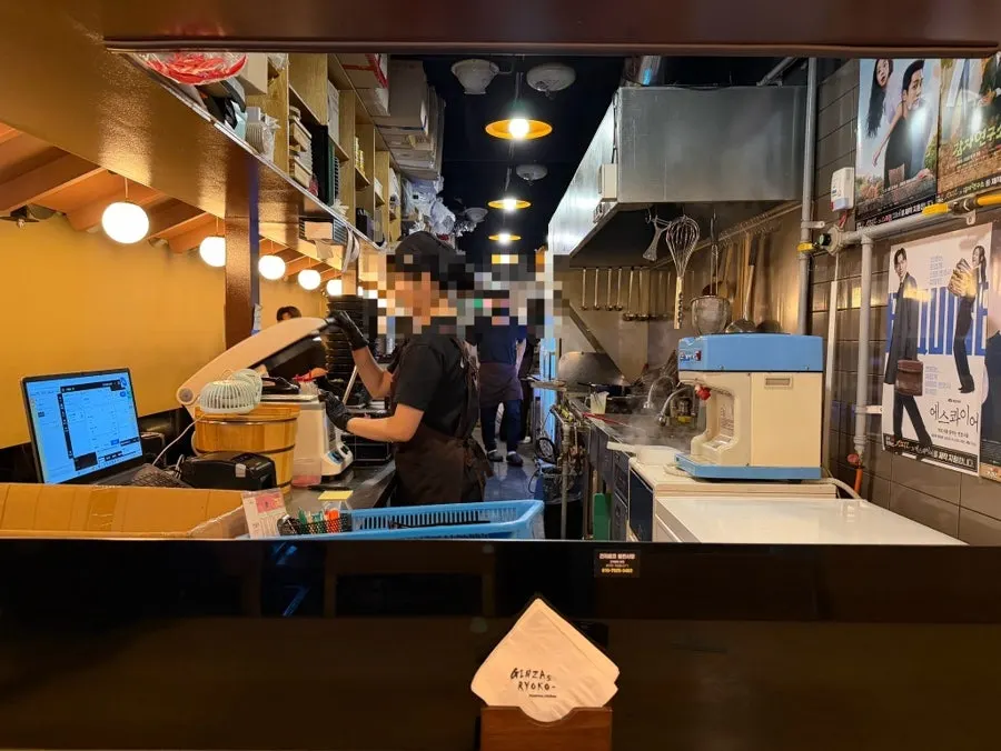 Interior with tachi seating, giving a Japanese restaurant feel