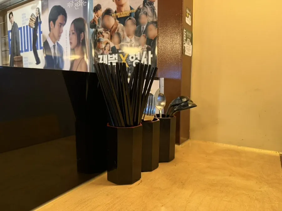 Table set with napkins, chopsticks, and an udon spoon
