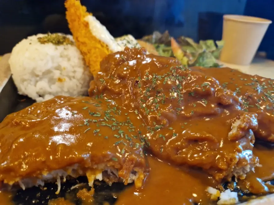A piece of demiglace pork cutlet with yellow mustard