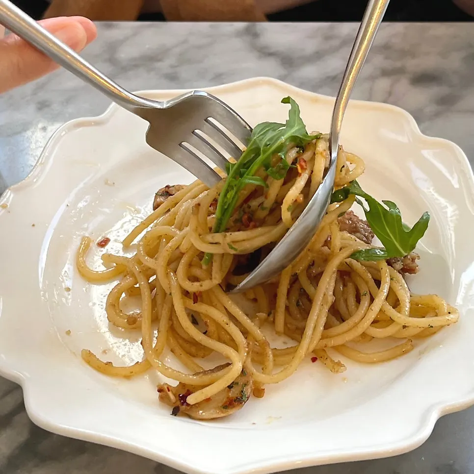 Noodles lifted with a fork from the anchovy oil pasta