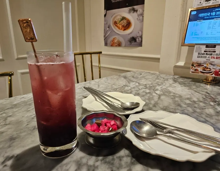 A glass of blueberry ade topped with blueberries