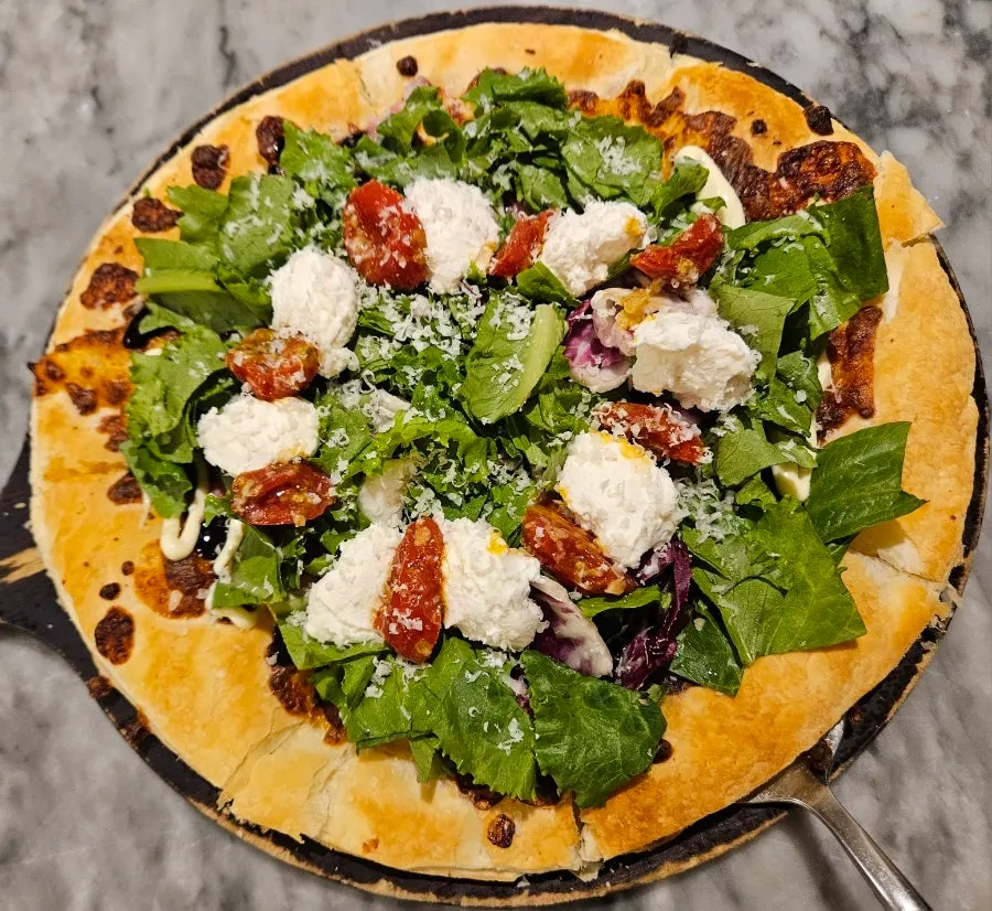 Ricotta salad pizza topped with arugula