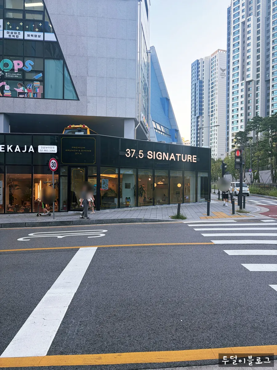 Entrance of 37.5 Signature Mia Branch and surrounding buildings