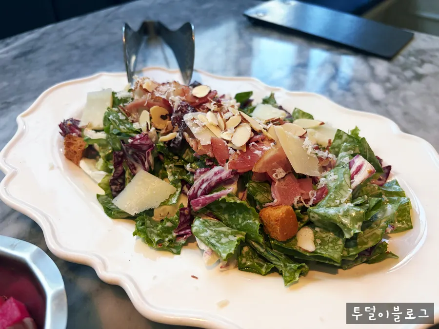 Close-up of cheese and dressing on the Caesar salad