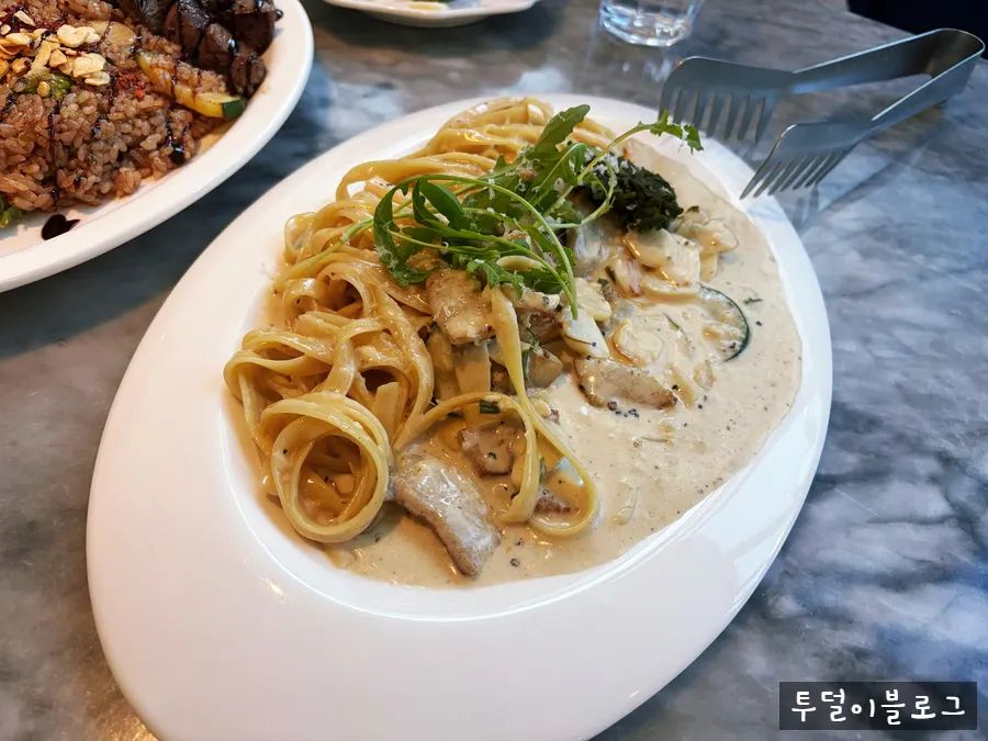 Plate of pork jowl green onion cream pasta