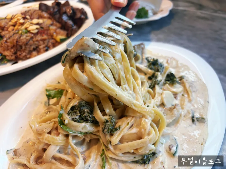 Pork jowl green onion cream pasta wound around a fork