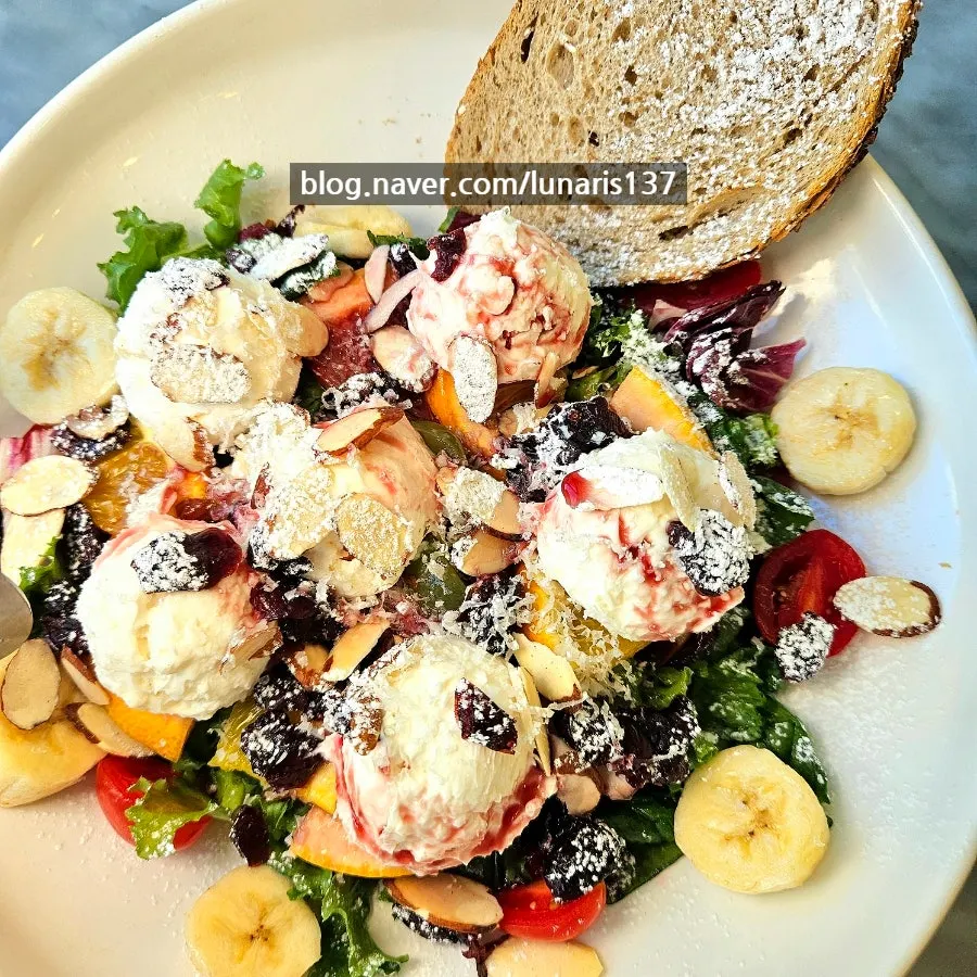 Ricotta salad topped with seasonal fruit and nuts