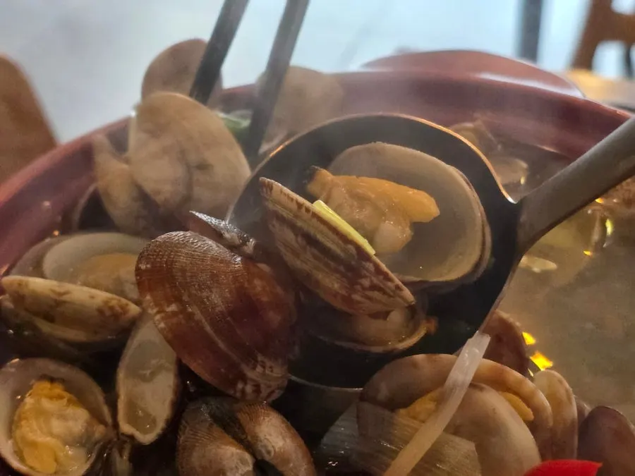 Clam soup broth full of clams