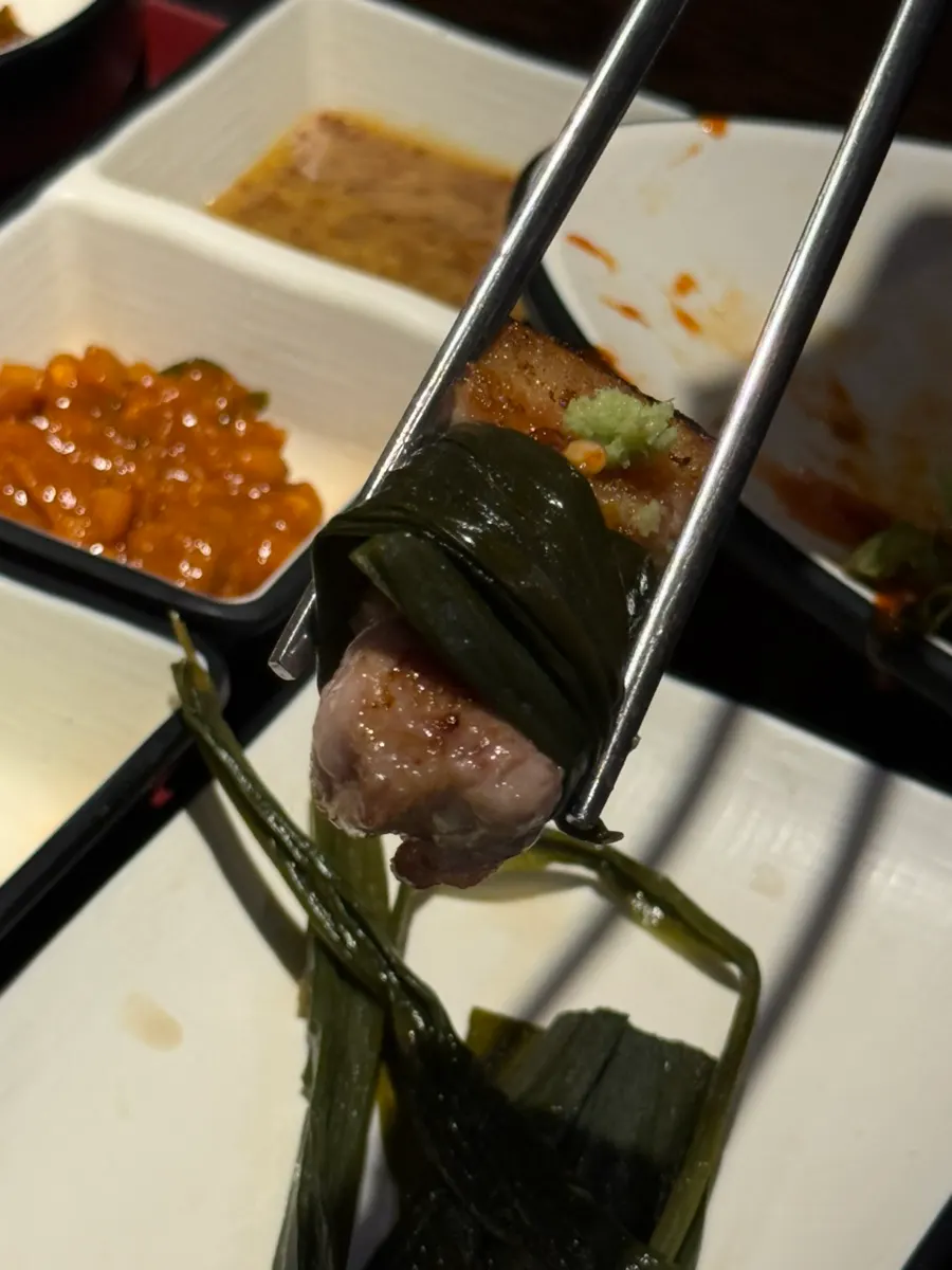 Samgyeopsal wrapped in wild garlic leaves with fresh wasabi