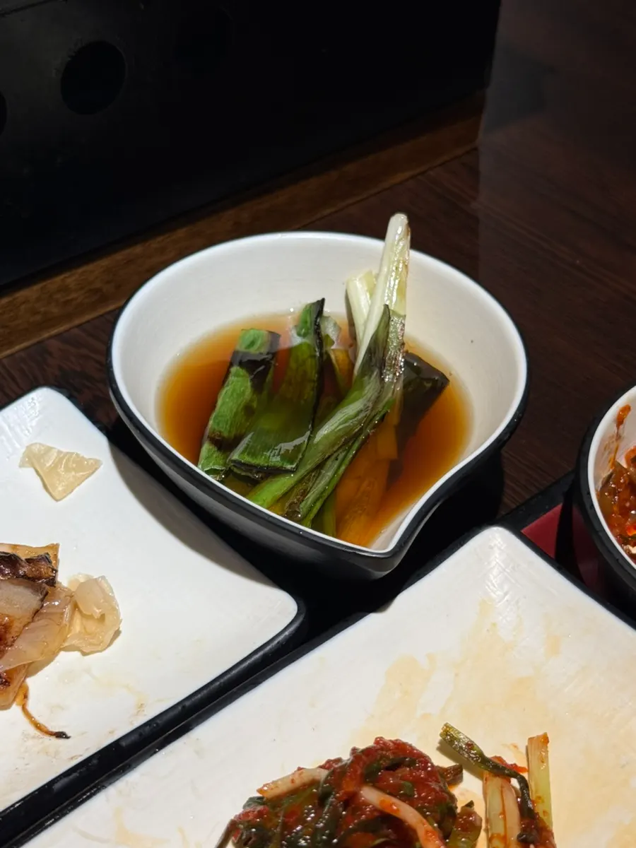 Additional meat and vegetables placed on the grill