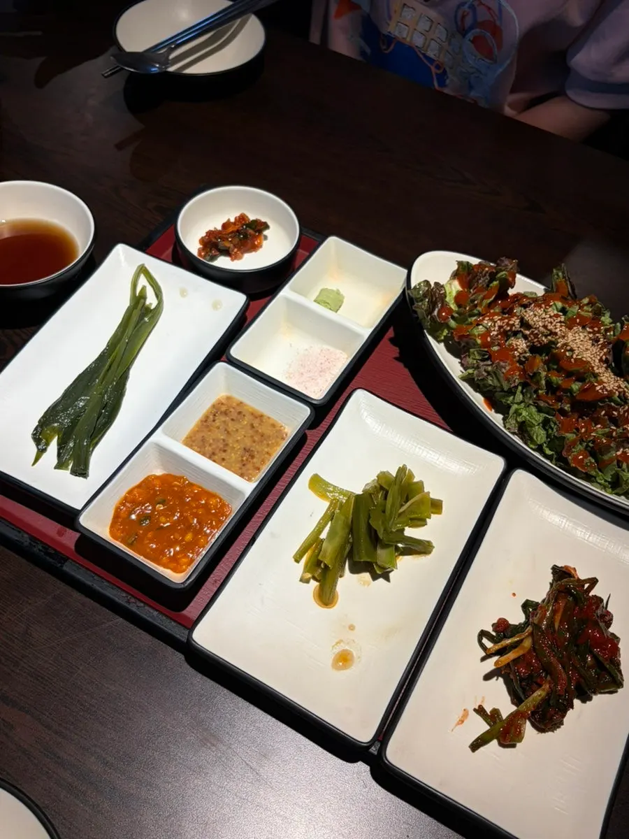 Banchan including scallion kimchi and marinated gungchae