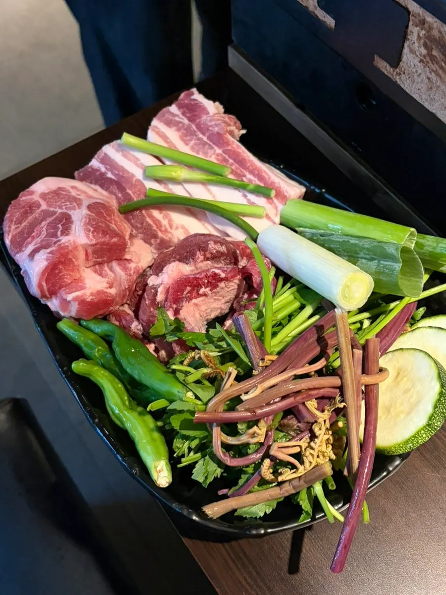 Charcoal grill pan set up for cooking meat