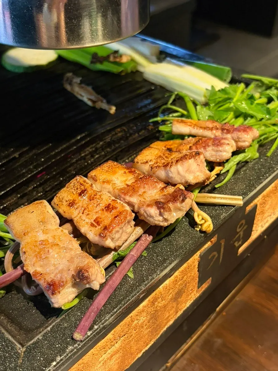 A piece of galbi-samgyeop dipped in pink salt