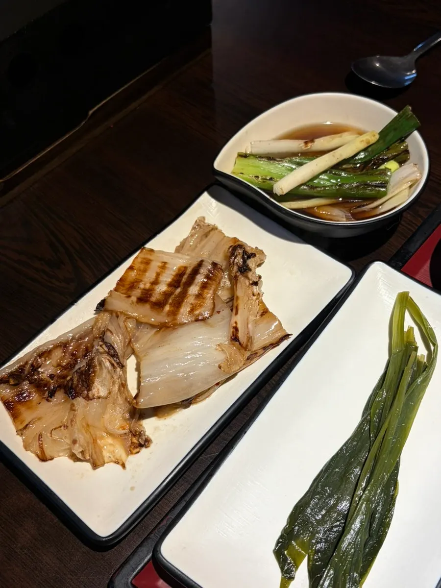 A piece of meat paired with myeongi namul and wasabi