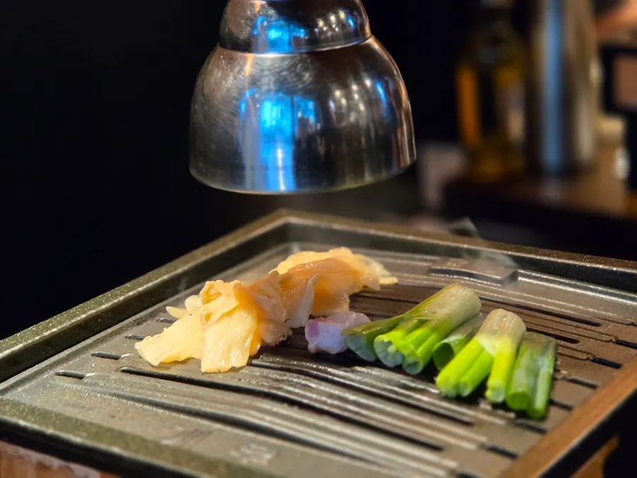 Grill topped with baek-kimchi and scallions