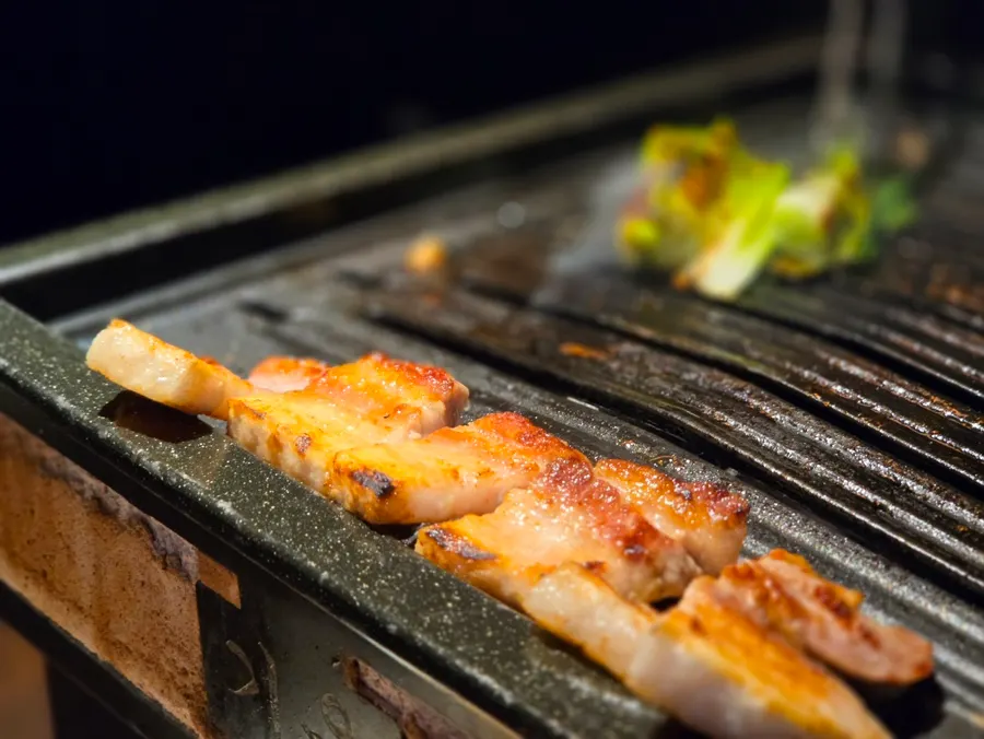 A piece of samgyeopsal grilled just crispy enough