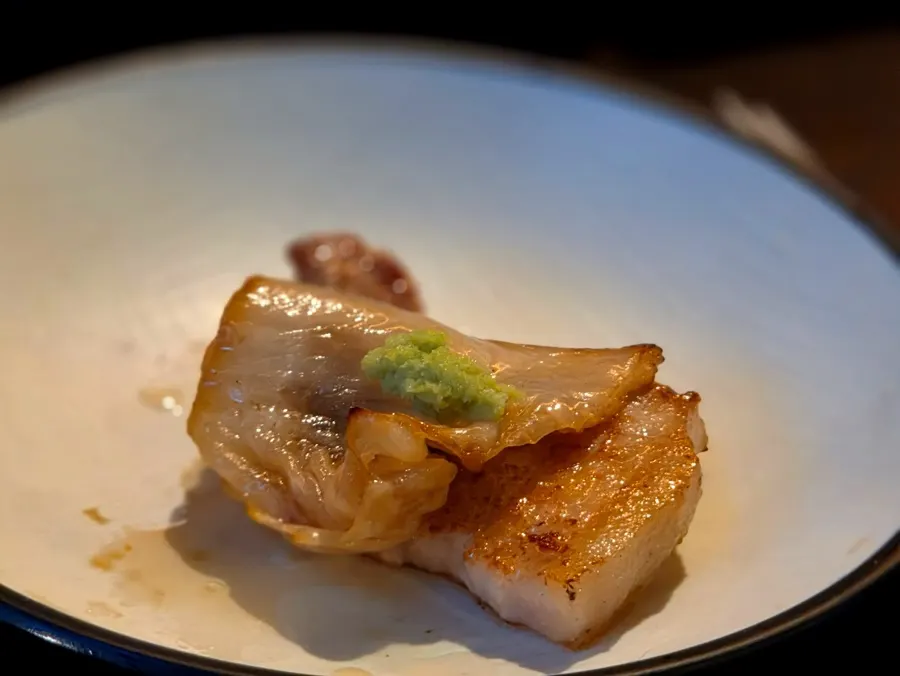 Samgyeopsal topped with baek-kimchi and wasabi