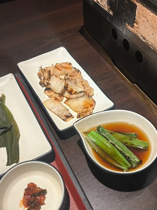 A piece of galbi samgyeopsal dipped in sauce