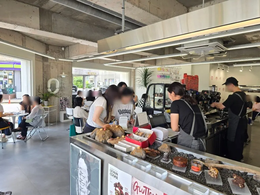 Seating area inside Gluttony Coffee packed with customers