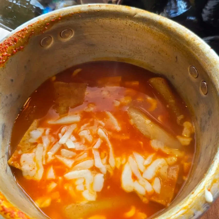 Pot of steamed clam soup packed with seafood