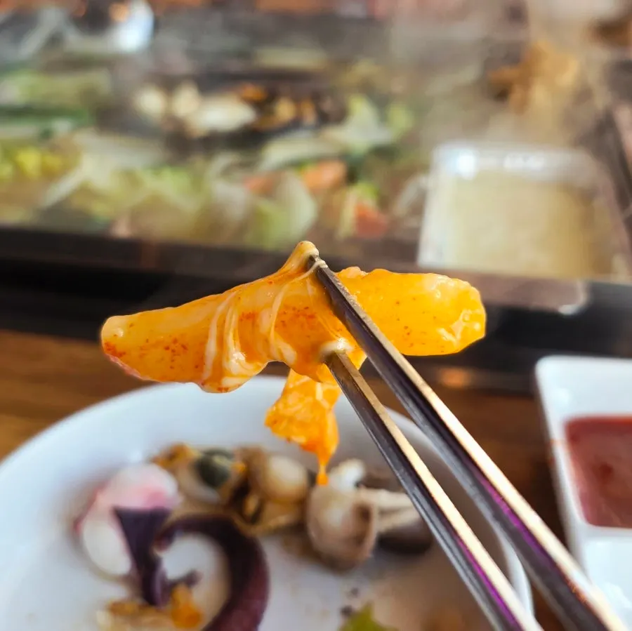 Cheese tteokbokki served as a complimentary side dish