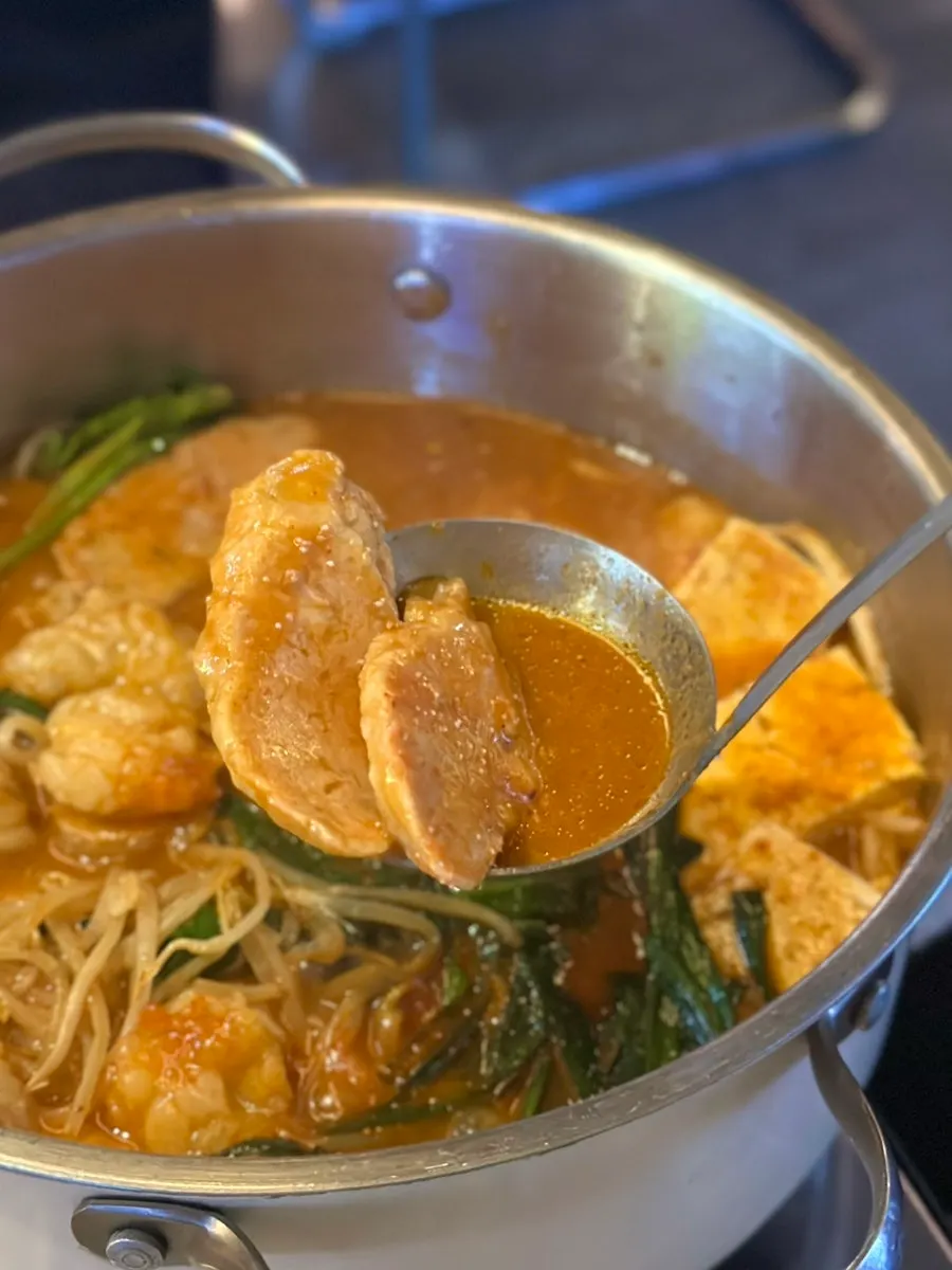 The spicy motsunabe broth simmering