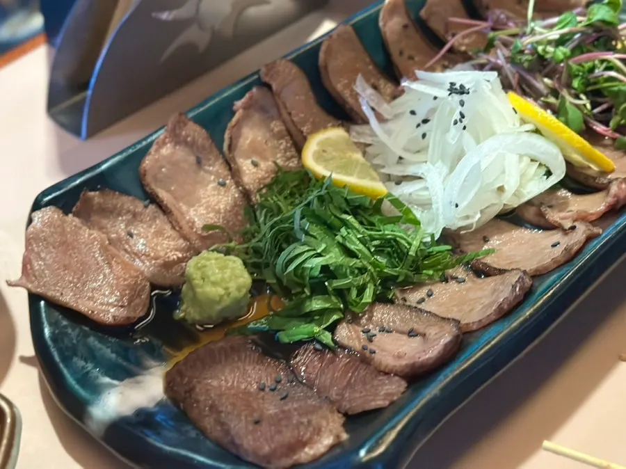 Beef tongue tataki served with perilla leaf, onion, and wasabi sauce