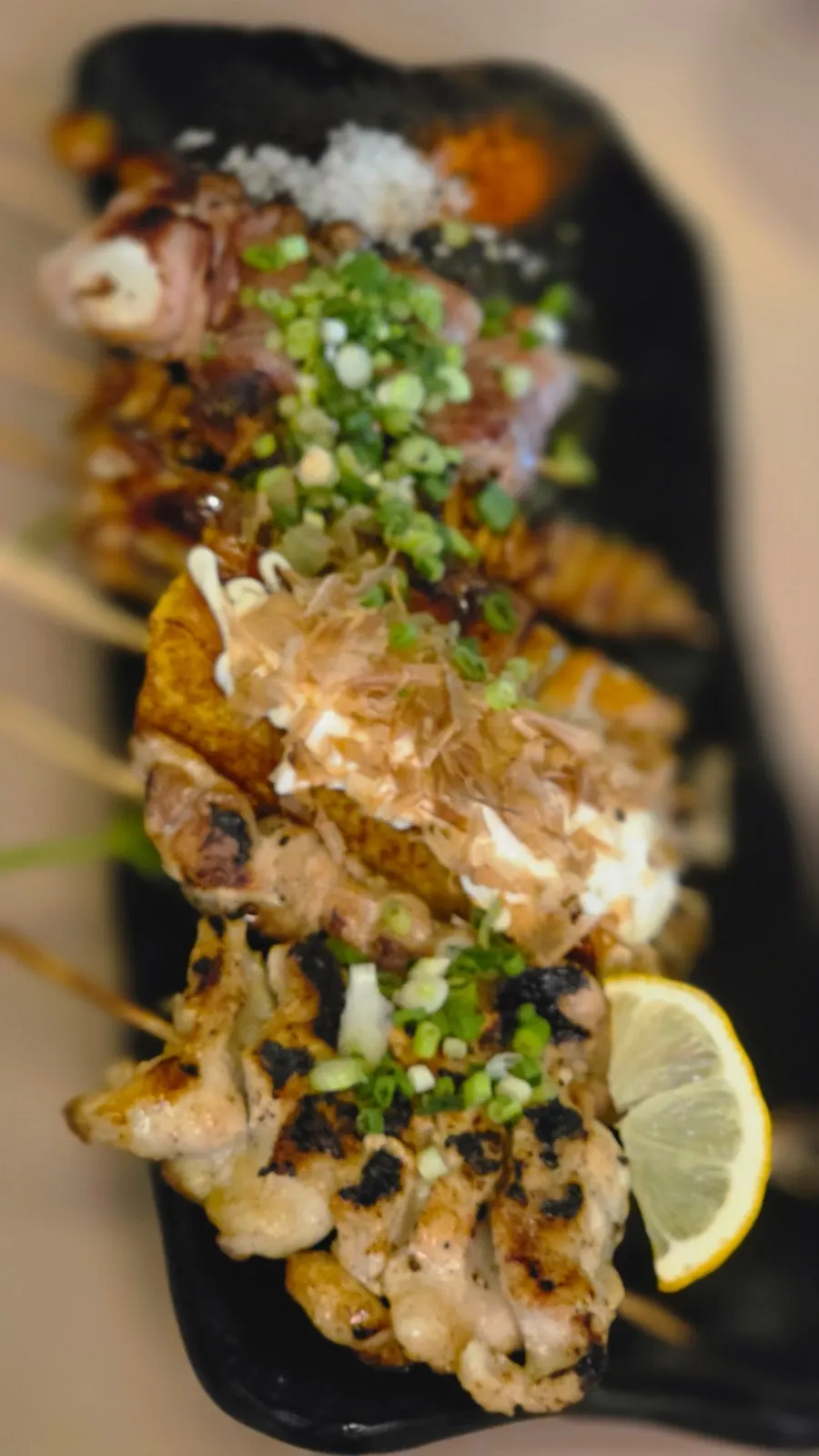 Assorted skewers arranged on a long plate