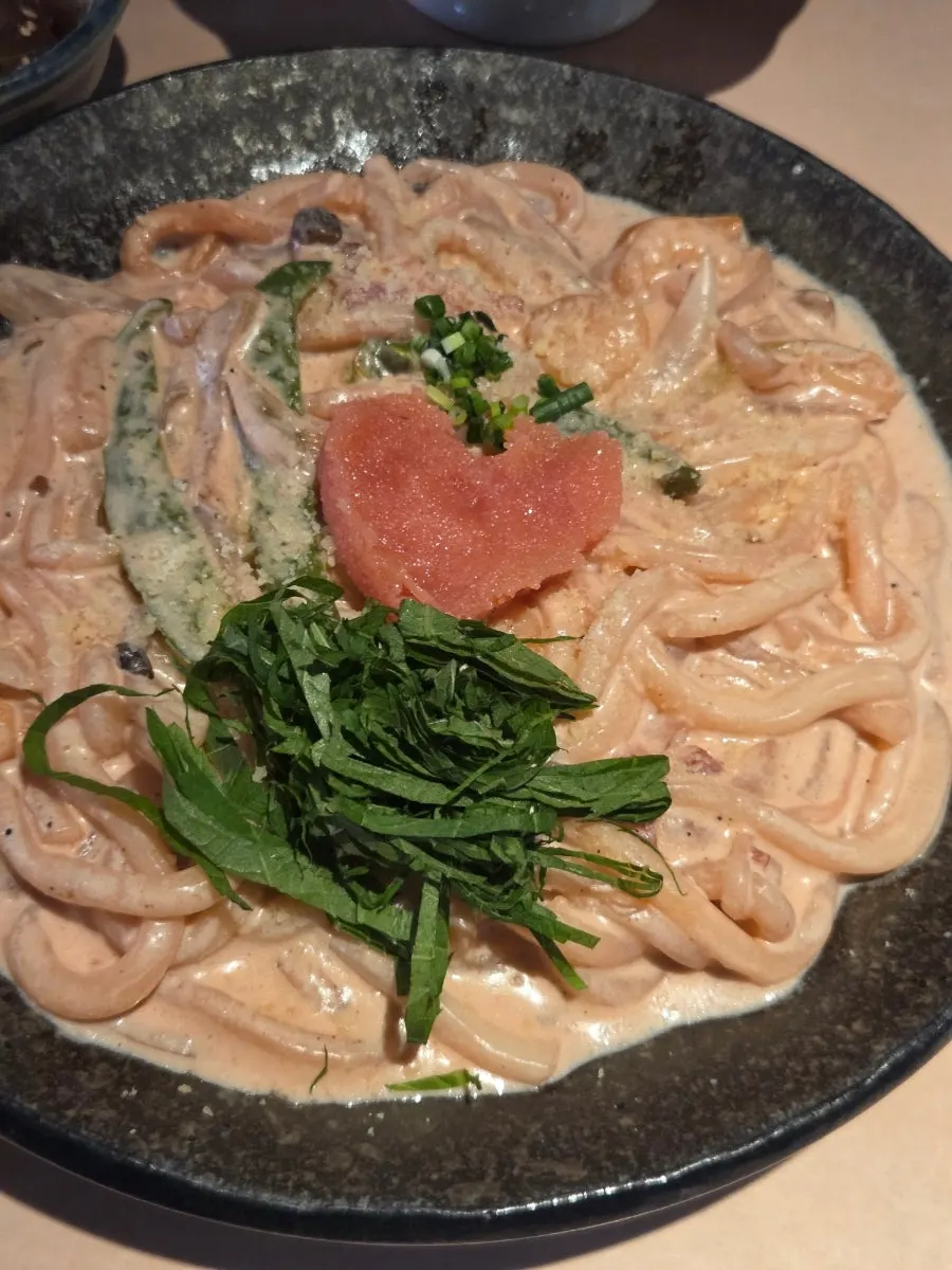 Mentaiko cream udon noodles mixed with mentaiko and vegetables
