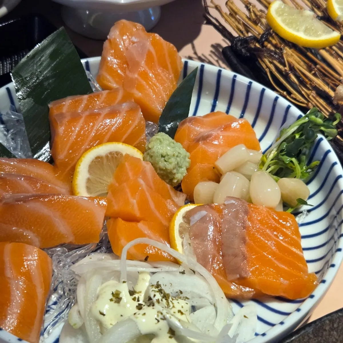 Thickly sliced salmon sashimi served over ice