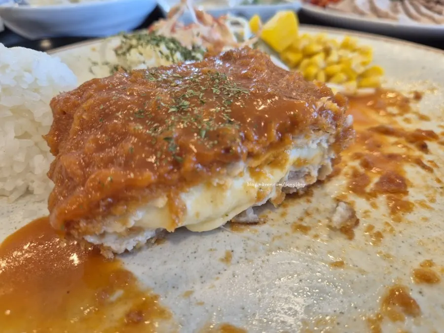 Cross-section of the pork cutlet showing generous cheese filling