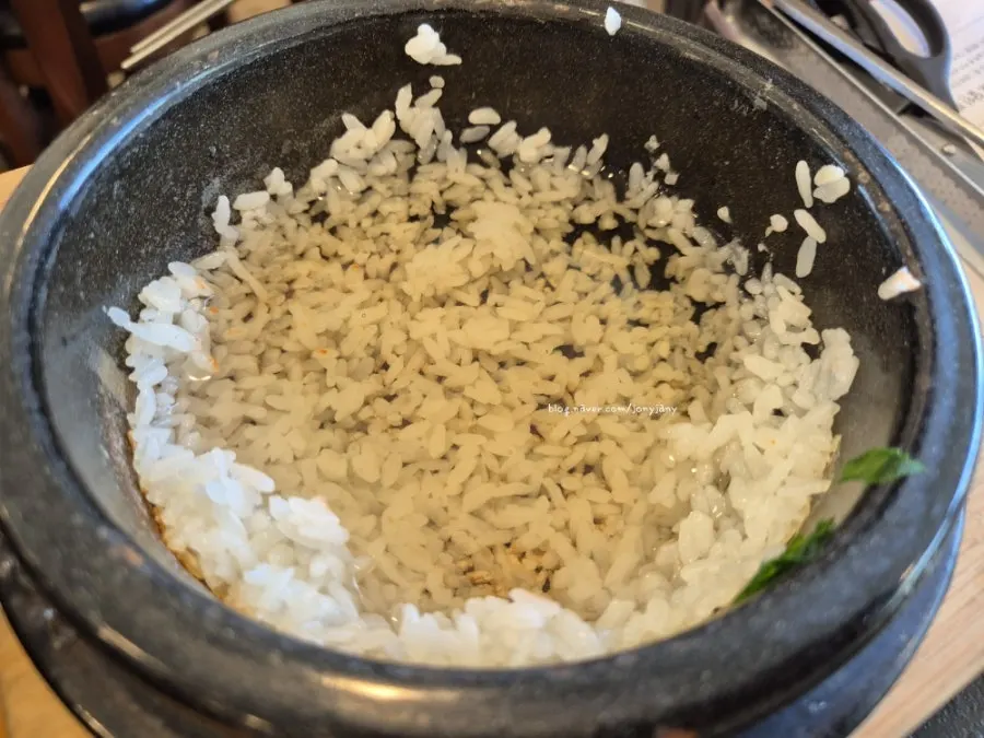 Glistening hot pot rice scooped into a bowl